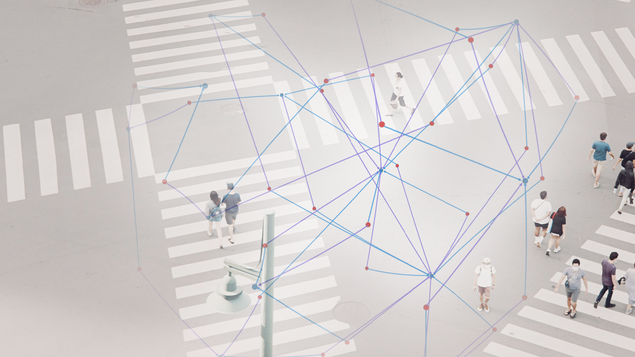 Overlay of a digital network map on top of a bird's-eye view of pedestrians crossing at a crosswalk.