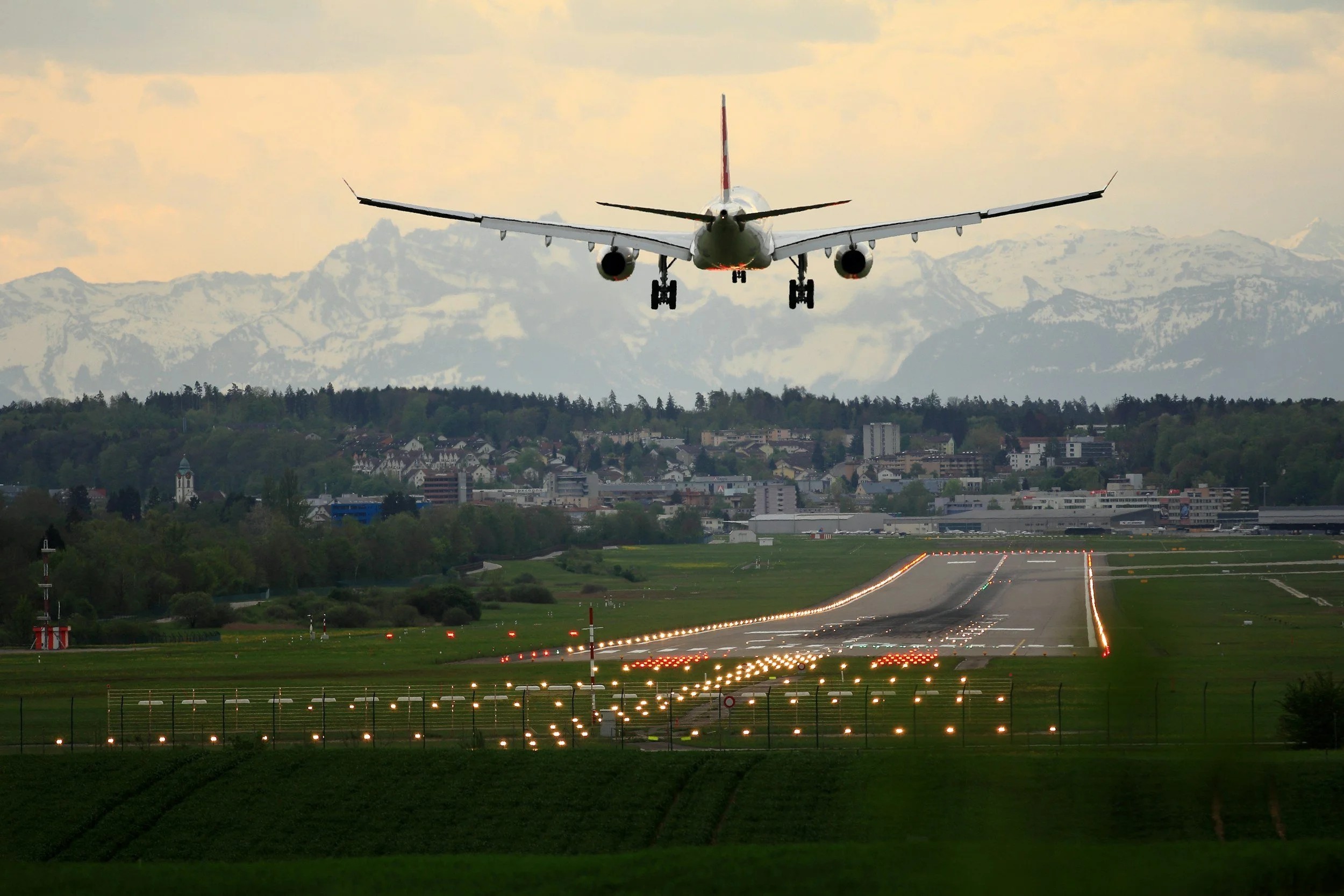 A private jet landing near an alpine city